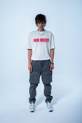 Model in the Haresquare vintage white tshirt with F*CK SOCIETY graphic print in red, styled with Haresquare gray cargo pants – unisex luxury streetwear from Ireland.